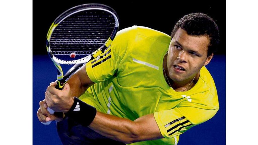 France's Jo-Wilfried Tsonga returns a shot on his way to victory against Serbia's Novak Djokovic in their quarter-final match at the Australian Open in Melbourne yesterday. - (Photgraph: Mick Tsikas/Reuters)