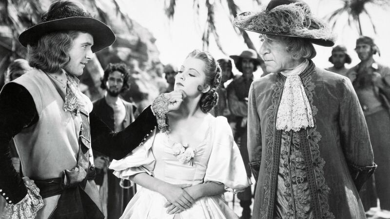 Olivia de Havilland with Errol Flynn and Henry Stephenson in Captain Blood, 1935. Photograph: Getty Images