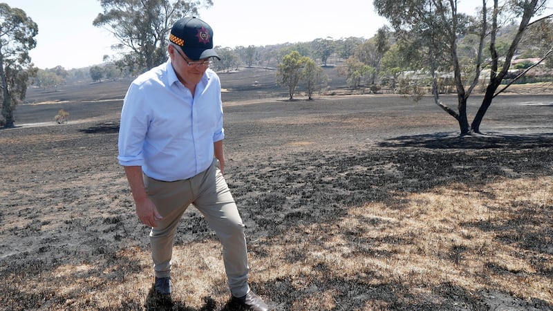 Australian prime minister Scott Morrison stands on burnt ground of Jacaranda Drive in Woodside on Christmas Eve. Photograph: Kelly Barnes/EPA