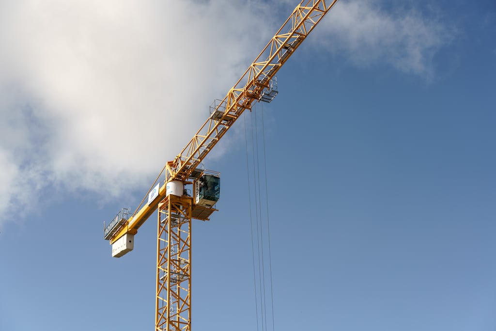 A crane at a residential construction site in Sandyford, south Dublin, Ireland, on Tuesday, May 11, 2021. The mass purchase of affordable houses  on the market for about 400,000 euros ($490,000)  set off a public firestorm and highlights the growing tension over the squeeze in urban housing and the role of large investors. Photographer: Paulo Nunes dos Santos/Bloomberg