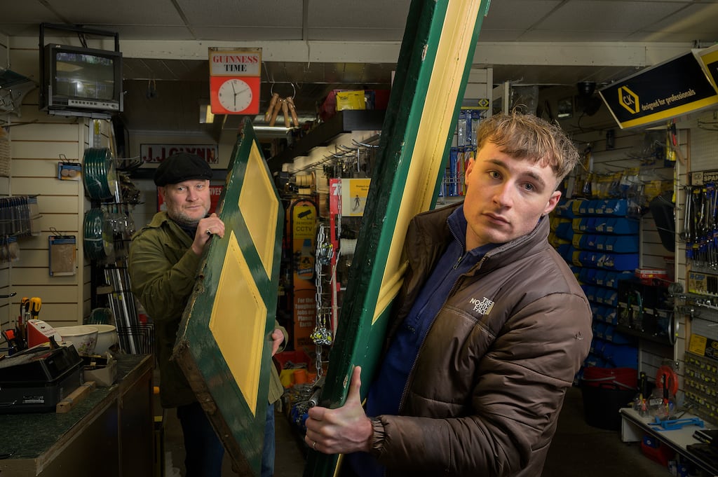 Father and son Dave and Rory Warde will hang the two exterior doors for the last time on Shop Street. Photograph: Michael Mc Laughlin
