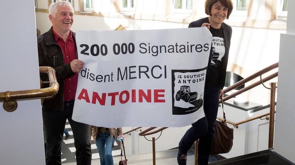 People holding a placard reading: “200,000 signatures say Thank you Antoine” at the trial of three men accused of leaking thousands of confidential documents revealing corporate tax deals. Photograph: Julien Warnand/EPA