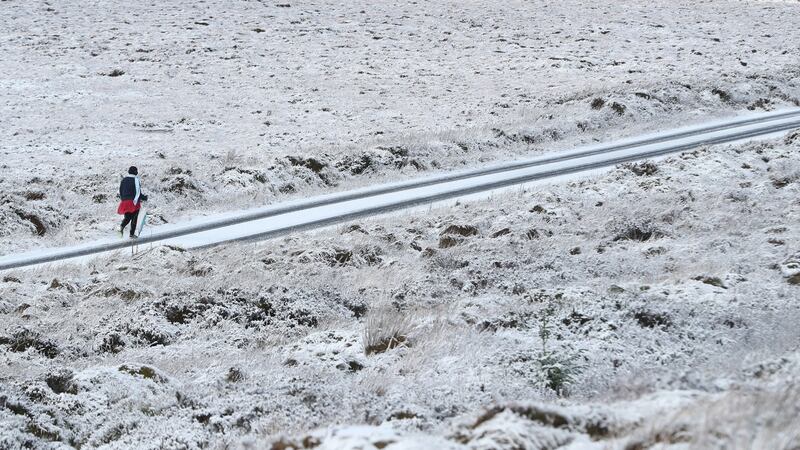 A walker enjoys the snow in the mountains near Killakee, to the south east of Dublin. Photograph : Niall Carson/PA Wire