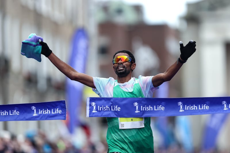 Daniel Mesfin (USA) crosses the line to win the men's race. Photograph: Bryan Keane/Inpho