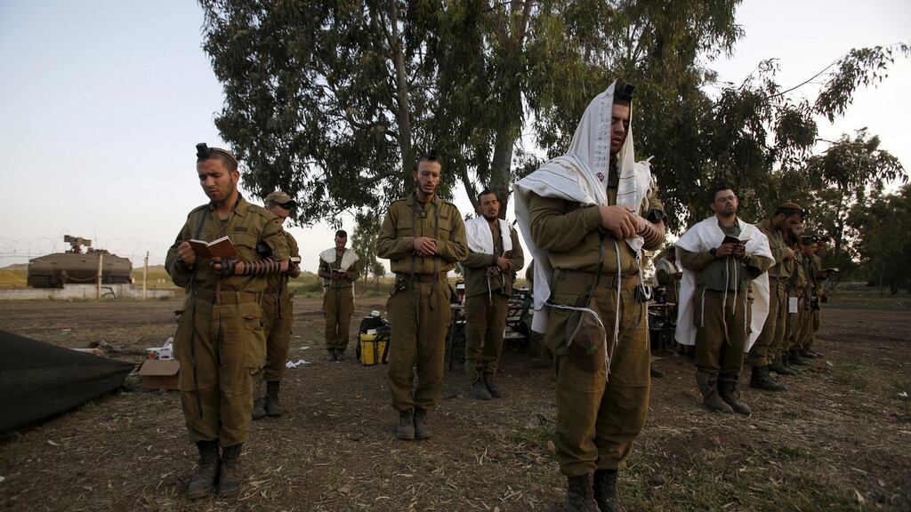Israeli soldiers pray close to the border between Israel and Syria on the Golan Heights. File photograph: Baz Ratner/Reuters