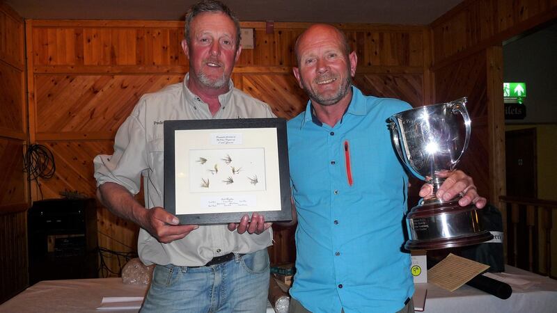 Pádraic Traynor presenting the Tolan and Traynor Perpetual Cup and a framed set of flies to winner of the Lough Conn two-day fly-fishing competition, Noel Shiels.