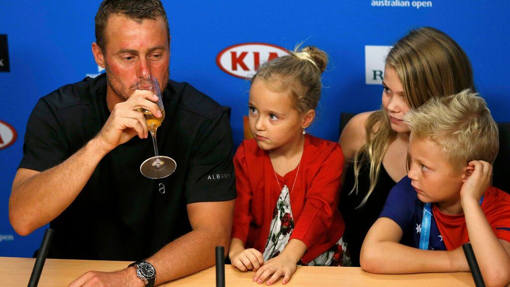 Australia’s Lleyton Hewitt drinks champagne during a news conference while his children, Ava, Mia and Cruz, watch after playing his last Australian Open singles match before his retirement. Photograph: Issei Kato/Reuters