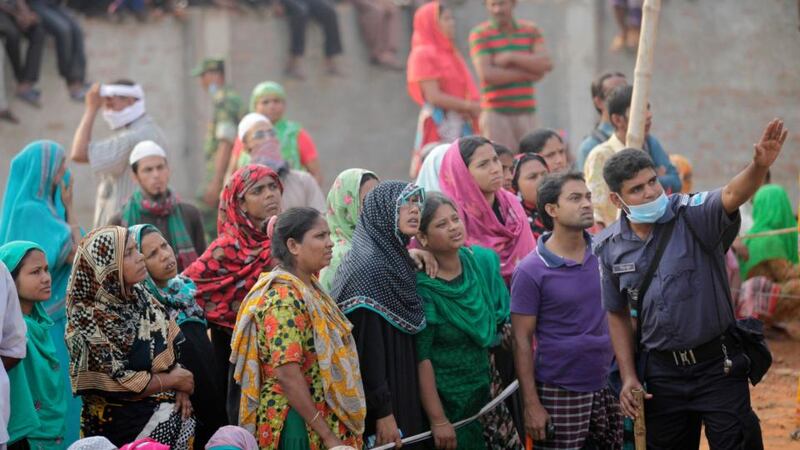 Crowds gather outside the collapsed Rana Plaza building in Savar, outside Dhaka, Bangladesh. Photograph: Andrew Biraj/Reuters