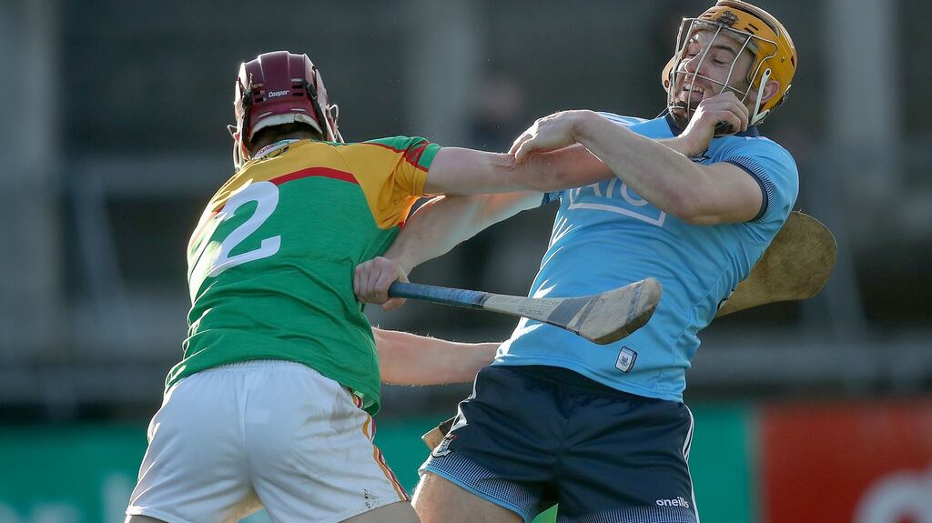 Carlow’s Alan Corcoran and Eamonn Dillon of Dublin scuffle off the ball during the Bord na Mona Walsh Cup match at Parnell Park. Photograph: Bryan Keane/Inpho
