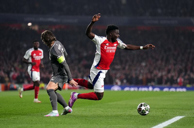 Arsenal's Bukayo Saka is fouled by Real Madrid's Luka Modric. Photograph: John Walton/PA Wire