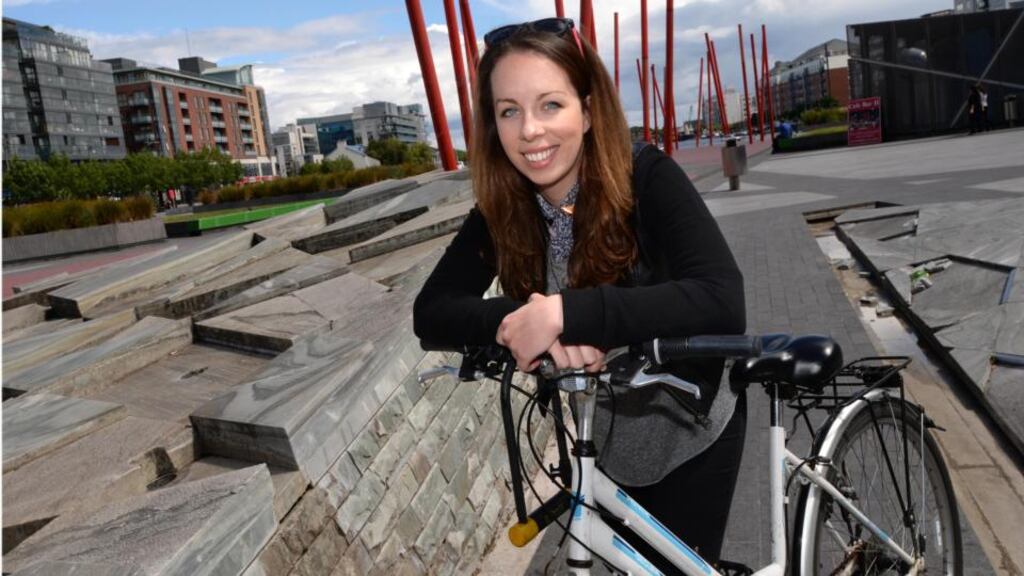 Meadhbh McHugh, with her not-so-beloved bicycle in Grand Canal Square, Dublin. Photograph: Dara Mac Dónaill