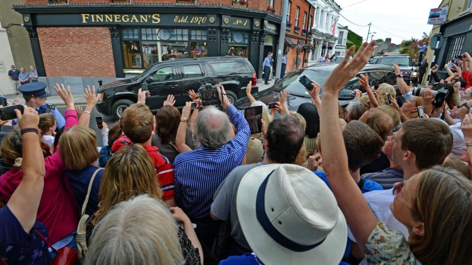 he crowd cheer as the cavalcade carrying the US First Lady Michelle Obama and her daughters, Malia and Sasha, pases through Dalkey Co Dublin today.  Photograph: Eric Luke / THE IRISH TIMES