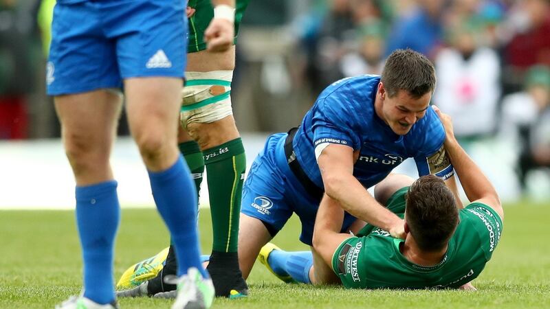 Johnny Sexton tangles with Dave Heffernan. Photograph: James Crombie/Inpho