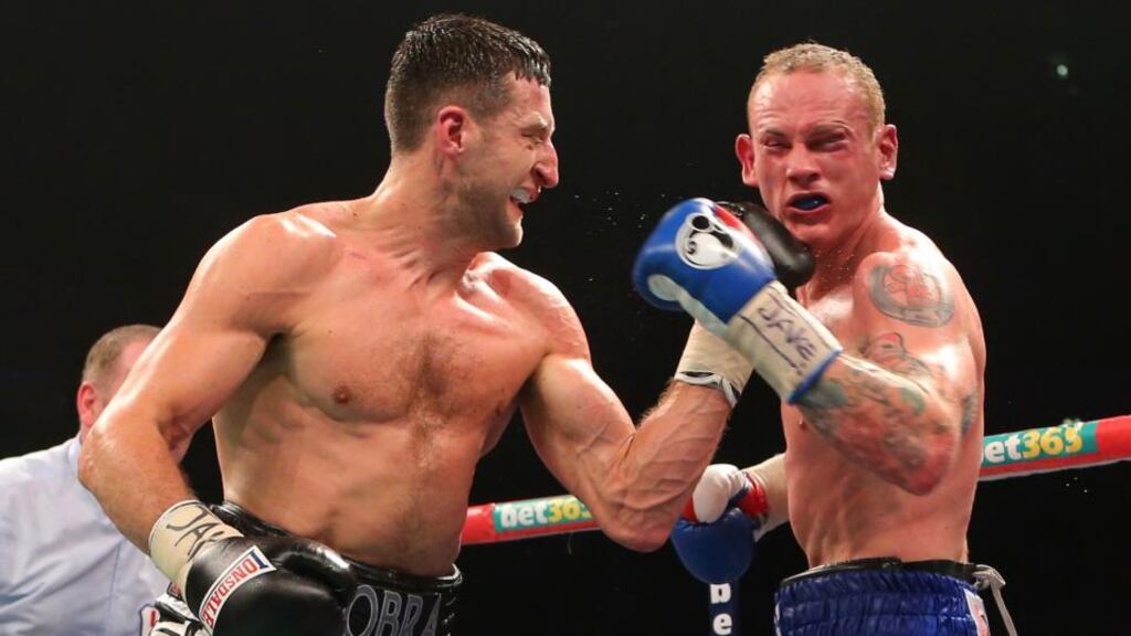 Carl Froch catches  George Groves with a left uppercut during their WBA and IBF super-middleweight title fight in Manchester. Photograph: Dave Thompson/PA