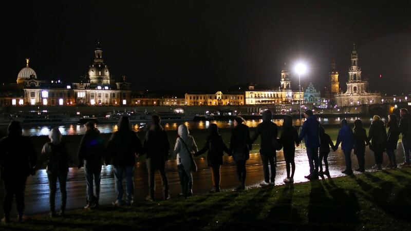 A human chain along the Elbe river in front of the Dresden historical city centre commemorates the 75th anniversary of the fire bombing of Dresden. Photograph: Ronny Hartmann/AFP