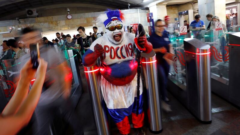 Zomo, a football fan from Cameroon walks into Okhotny Ryad metro station in Moscow. Photograph: Kai Pfaffenbach/Reuters