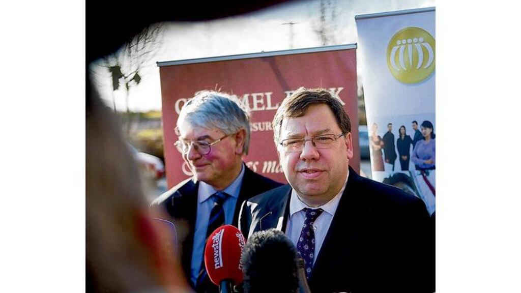 Taoiseach Brian Cowen, with junior minister Martin Mansergh, talks to the media during Clonmel Chamber of Commerce's "Yes We Can" conference in Clonmel, Co Tipperary, yesterday.