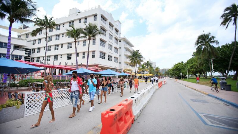 People walk down Ocean Drive in the South Beach area of Miami Beach, Florida. Photograph: Cliff Hawkins/Getty Images