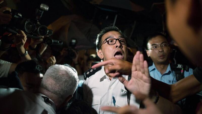 Pro-democracy protesters clash with police officers on a street outside of Hong Kong Government Complex tonight. Photograph: Anthony Kwan/Getty Images