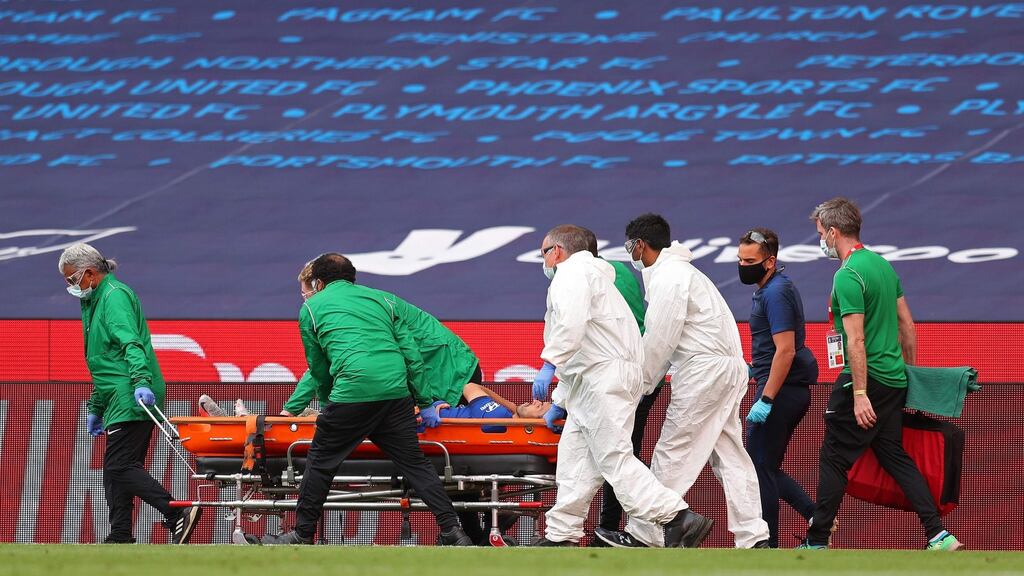 Medics carry Pedro off of the pitch in the closing minutes of the FA Cup final. Photograph: Getty Images