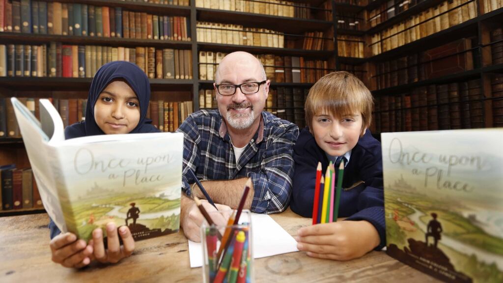 The new Laureate na nOg PJ Lynch in Marsh’s Library for the launch of Once upon a Place, which he illustrated and which was edited by his predecessor, Eoin Colfer, with Mekhy Amkhadov, left, and Maymoonah Elagrabi. Photography: Sasko Lazarov/Photocall Ireland
