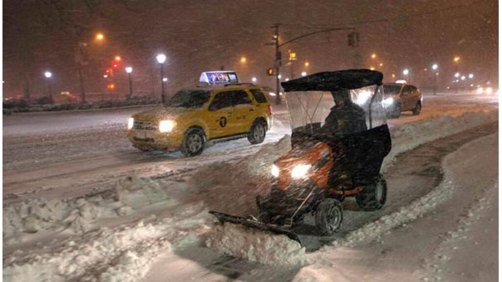 A snow plow blows snow in New York as a blizzard slammed into the northeastern part of the United States. Photograph: Keith Bedford/Reuters