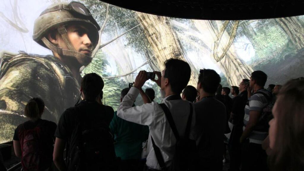 Some of the thousands of attendees at last year’s E3 watch a demonstration of Call of Duty at the Activision exhibit. Photograph: David McNee/Reuters
