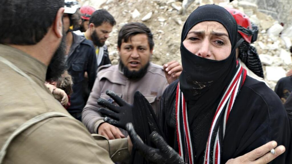 A woman cries as civil defence members carry her dead child after what activists said was shelling by military aircraft loyal to Syria’s president Bashar Al-Assad in Aleppo’s rebel-controlled Bab Al-Nairab district today. Photograph: Abdalrhman Ismail/Reuters