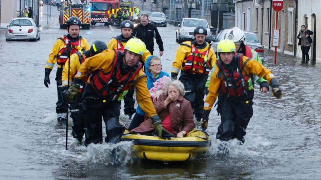Ann Pickford and her daughter, Audrey Considine, are rescued from their flooded home on Athlunkard Street in February. Photograph: Liam Burke/Press 22