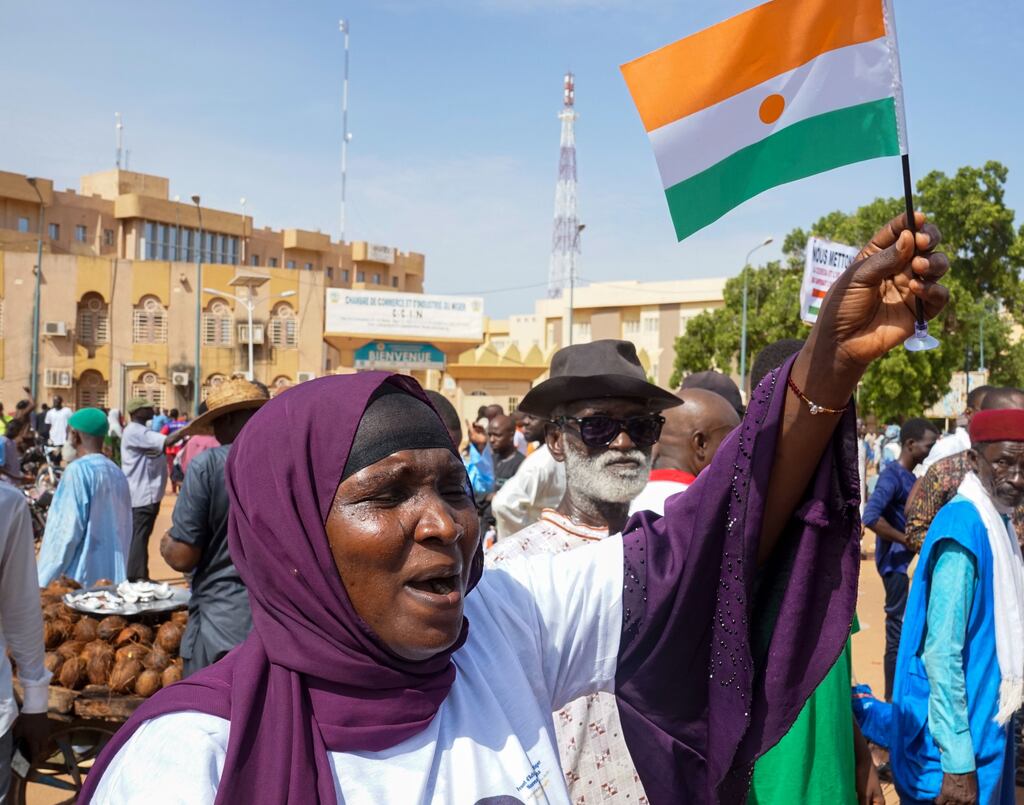 A woman with a Niger's flag during a protest in Niamey, Niger, 30 July 2023. Thousands of supporters of General Abdourahamane Tchiani, head of the Presidential Guard, who declared himself the new leader of Niger after a coup against democratically elected President Mohamed Bazoum on 26 July, took to the streets of Niamey to demonstrate support for the coup.