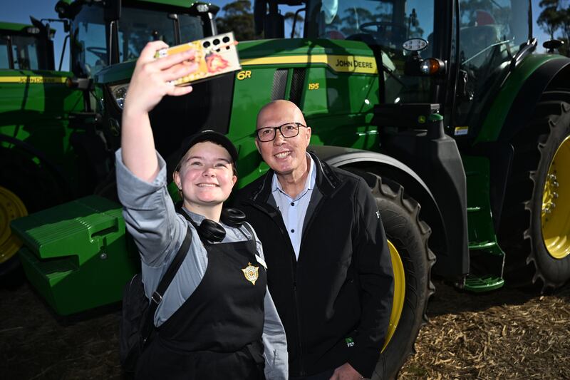 Australian opposition leader Peter Dutton (right) canvasses at an agricultural festival in Carrick, Australia, ahead of a general election on Saturday. Photograph: Dan Peled/Getty
