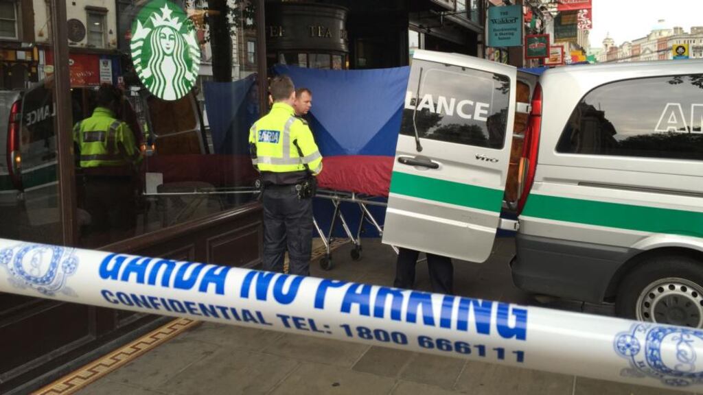 The body of a homeless man is removed by gardaí on Westmoreland Street. Photograph: Alan Betson