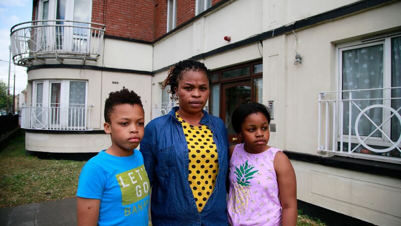 Ayo Adeshina with children Kenny (left) and Taiwo at the direct provision centre Watergate House on Usher’s Quay, Dublin. Photograph: Nick Bradshaw