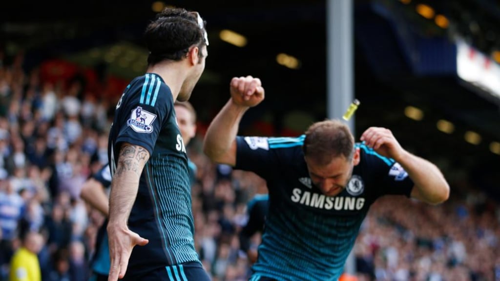 Branislav Ivanovic is struck by a cigarette lighter while celebrating Cesc Fabregas’ winner for Chelsea against QPR at Loftus Road. Photograph: Reuters