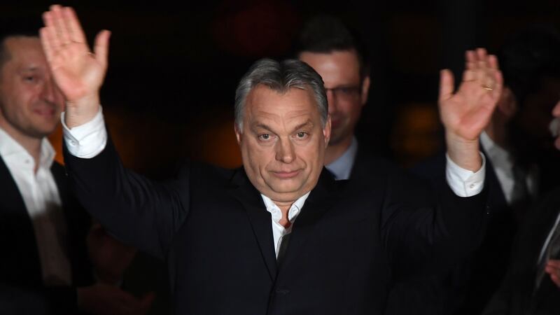 Hungarian Prime Minister Viktor Orbán celebrates on a podium on the bank of the Danube River after winning the parliamentary election with members of his Fidesz party on Sunday. Photograph: Attila Kisbenedek/AFP/Getty Images