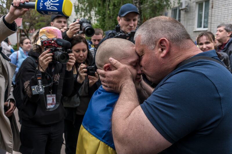 Oleh Los greets his son Andriy Los (23), who was in Russian captivity since November. Photograph: Brendan Hoffman/New York Times