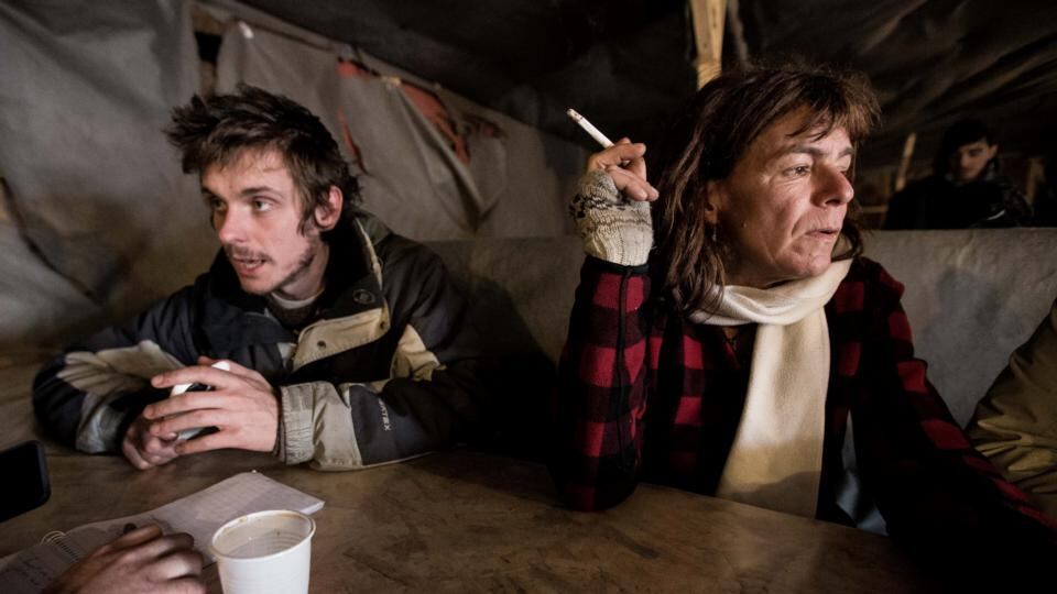 Surrogate mother: Liz Clegg – a swearing, chain-smoking version of Mother Teresa – is followed around the “Jungle” migrant camp by Afghan boys. Photograph: Charlie Forgham-Bailey