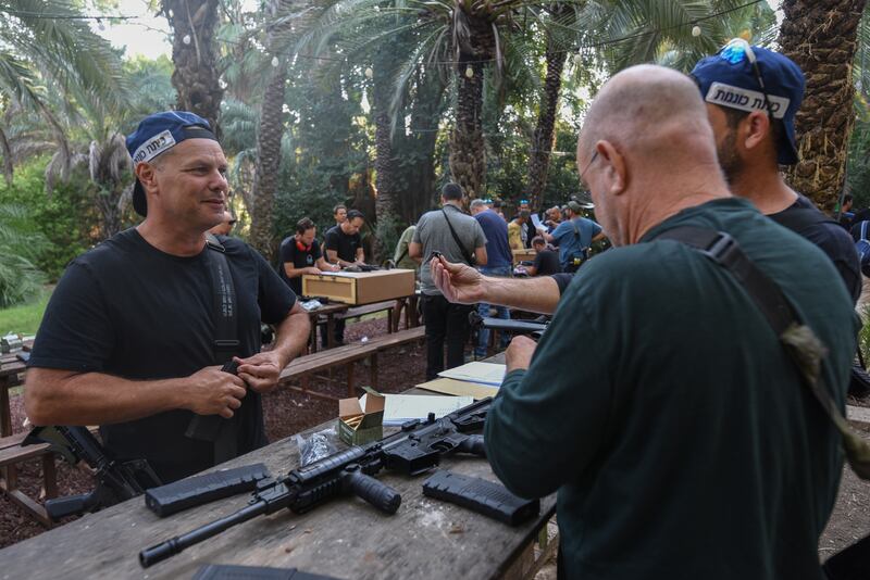 Israelis receive weapons at a distribution point for civilians at the Kibbutz of Ayyelet HaShahar in the Upper Galilee, northern Israel, close to the border with Lebanon, on Thursday. Photograph: Ayal Margolin/EPA