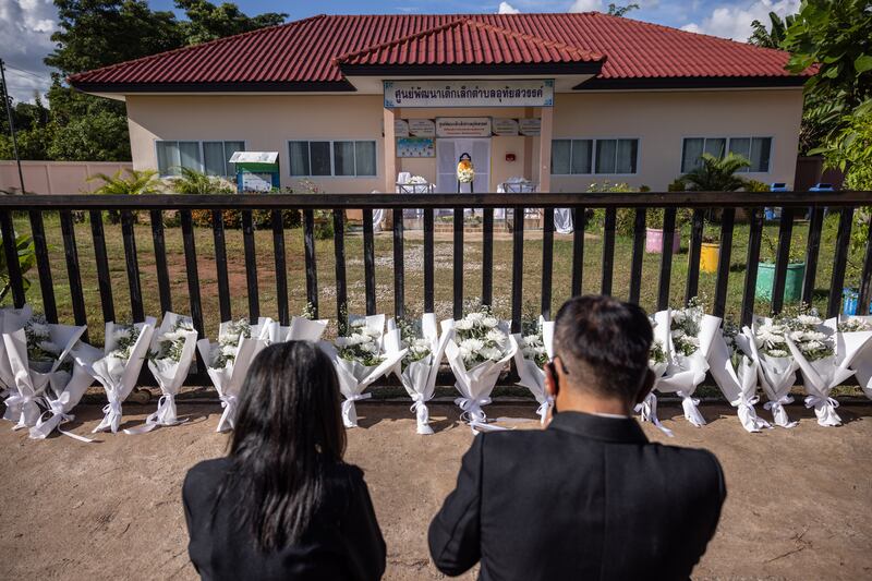 Mourners pray on Friday outside the day care centre in Uthai Sawan, Thailand where 23 children were killed in a knife and gun attack the previous day. Photograph: Andre Malerba/New York Times