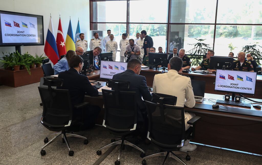 Russian (back) and Ukrainian (front) military delegation at the opening of the Joint Co-ordination Centre in Istanbul. The aim is to monitor the export of grain from Ukraine's Black Sea ports of Odesa, Chornomorsk and Pivdenny. Photograph: Erdem Sahin/EPA