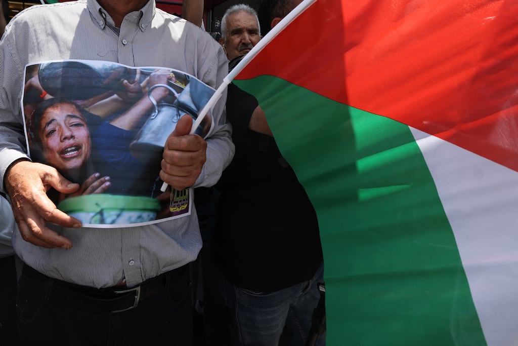 A Palestinian man carries a placard and waves the national flag during a demonstration in support of Palestinians in Gaza in the city of Nablus, in the Israeli occupied West Bank on July 22nd. Photograph: Jaafar Ashtiyeh/AFP