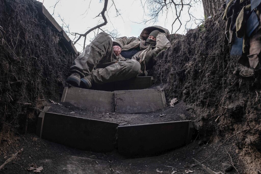 A Ukrainian soldier takes a rest in a trench on the frontline in the Donetsk region. Photograph: Iryna Rybakova via AP
