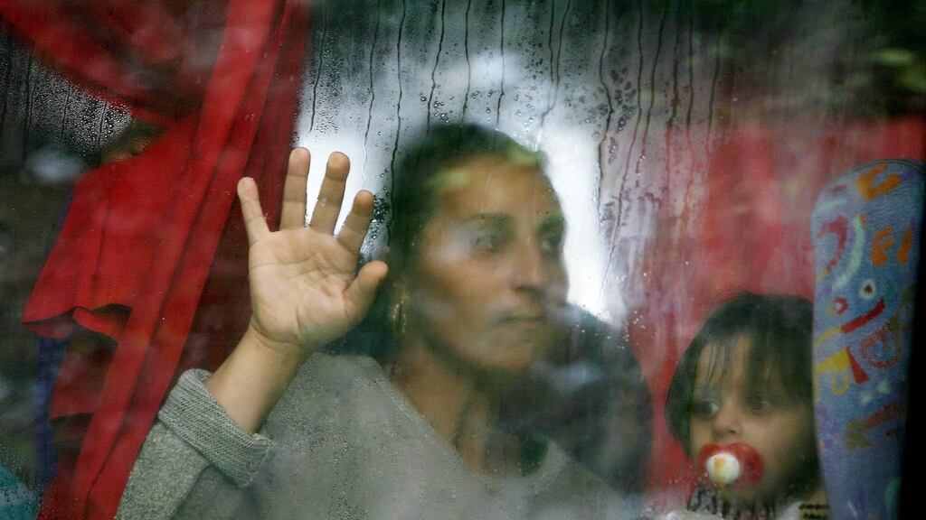 Romanians leave the Lisburn Road area of Belfast on a coach after being forced out by racist groups in 2009. File photograph: Niall Carson/PA Wire