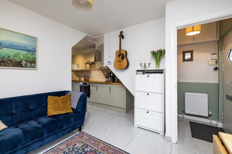 The living space, which has a solid-fuel cassette stove, continues into the kitchen