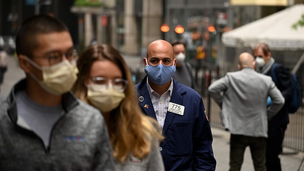 A trader walks in front of the New York Stock Exchange (NYSE) on Tuesday as physical floor trading resumed. Photograph: AFP