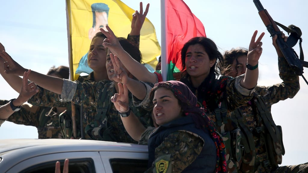 Yazidi soldiers cheer a fallen comrade near Sinjar, Iraq. Kurdish forces, with the aid of US-led coalition air strikes, liberated Sinjar from IS extremists in recent days. Photograph: Getty Images