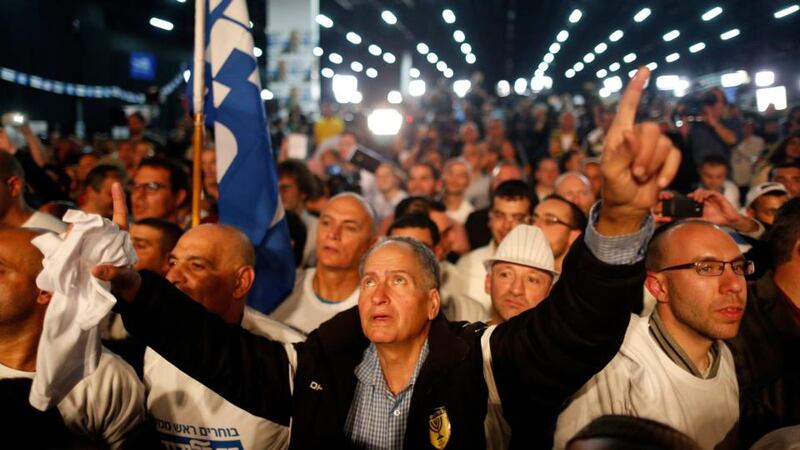 Supporters of Binyamin Netanyahu cheer as they hear the first television predictions of results after polls for the Israeli general elections closed. Photograph: Abir Sultan/EPA