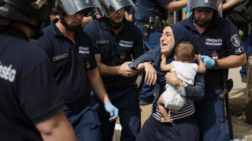 Police seek to detain a woman and child after a train from Budapest heading to the Austrian border was stopped in Bicske, west of the Hungarian capital, on September 3rd, 2015. Photograph: Istvan Bielik/AFP/Getty Images