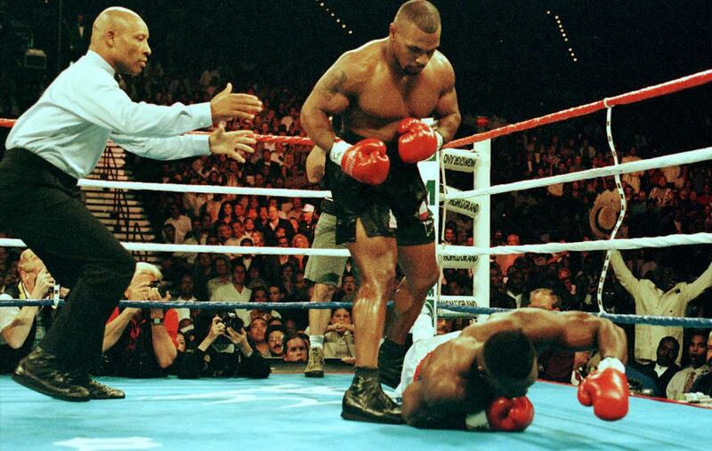 Mike Tyson stands over Bruce Seldon after knocking his opponent down during their fight in Las Vegas in 1996. Photograph: Jeff Haynes/AFP via Getty Images)
