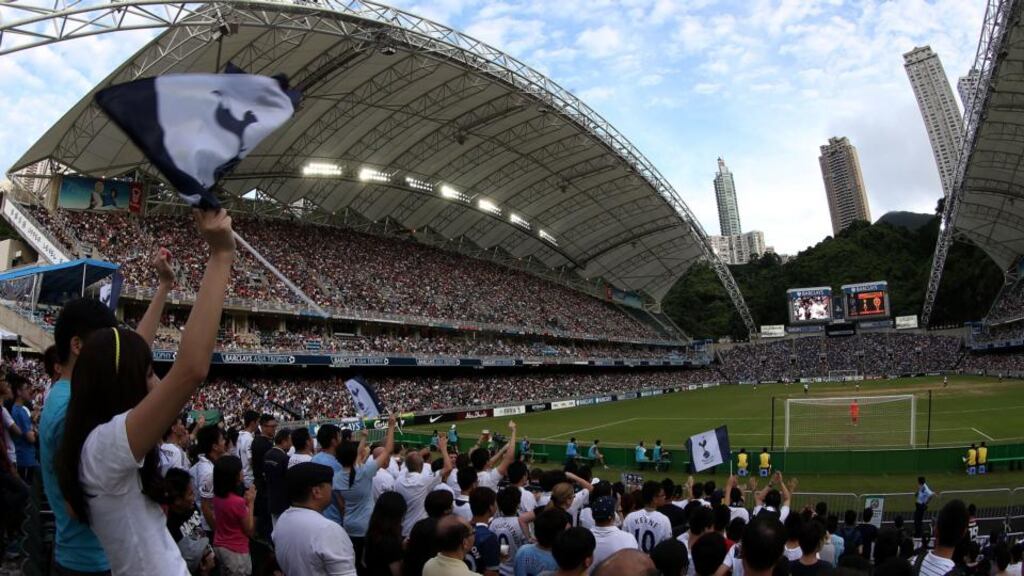 Fans cheer for their team during the  match between Tottenham and South China at Hong Kong Stadium recently